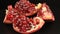 The pomegranate slices rotate. Fresh ripe fruit close-up.