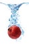 Pomegranate splashing in water