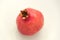 Pomegranate on white background, red, spine on top, six corners