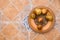 Pomegranates on pattered wooden plate. Tiles