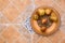 Pomegranates on pattered wooden plate. Tiles