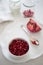 Pomegranates and yogurt play on white (Shallow DOF)