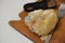 Pomelo pieces covered with green mold lying on the wooden cutting board