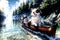 Pomeranian dog wearing sunglasses has adventure on the sea in a canoe