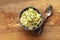 Pomme puree, an overhead photo of a bowl of mashed potatoes with herbs, shot from above on a rustic background