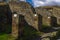 Pompeii, Italy Roman architecture city block remains with numbered homes entrances.