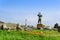 Pompeii ruins and bronze statue of Daedalus among poppies and green grass