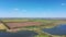 Pond and autumn agricultural fields. Harvesting.