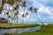 Pond, boat and sea among palm trees