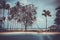 Pond, boat and sea among palm trees