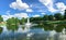 Pond with cloud reflection and water fountain in small American neighborhood