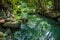 Pond with colorful colors and statue of a woman on a rock. In the royal Royal Palace of Caserta in Italy