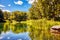 The pond, green grass and trees in La Fontaine park of Montreal, Canada