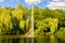 Pond, lake in the park, nature reserve, recreational area with fountain in the middle and with beautiful green trees in the backgr