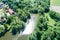 The pond at the moated castle Neuhaus from the air, with bushes and trees, at the edge of the village