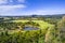 Pond and native trees among pastures.