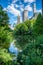 Pond in New York City Central Park at summer against skyscrapers and blue sky