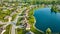 Pond property houses rich suburban neighborhood aerial