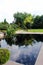 A pond reflecting the sky and trees in the Serenity Garden at Olbrich Botanical Gardens in Madison, Wisconsin