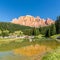 Pond with Torri del Sella mountain in background at the road to Canazei - Italy