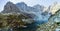 Pond in a valley surrounded by magnificent peaks seen in the morning.