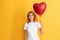 pondering redhead girl with love heart balloon. be my valentine