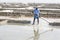 PONDICHERY, PUDUCHERRY, TAMIL NADU, INDIA - MARCH CIRCA, 2018. Unidentified men workers picking up, collecting the salt, in big