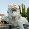 Ponorogo 11 September 2023 White lion statue in Ponorogo square in the afternoon, trees and buildings, blue sky