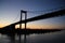 Pont d`Aquitaine bridge at sunset. It is a large suspension bridge over the Garonne, north-west of the city of Bordeaux, France