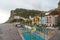 Ponta do sol beach with palm trees and colorful houses in the east of Madeira in summer.