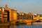 The Ponte Santa Trinita over Arno river, seen from the attractive promenade Lungarno Guicciardini in Florence. .