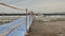 Pontoon bridge pier in the sea. people and pleasure boat