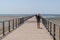 Pontoon Pier of Andernos les Bains France with young woman walking behind