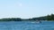 Pontoons on a beautiful lake in northern Minnesota with blue sky and fluffy clouds. Boating in Minnesota,