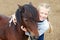 Pony and little girl and her best friend