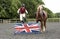 Pony rider jumping a low fence