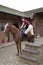 Pony rider using a mounting block