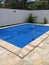 Pool in backyard with a thermal cover