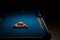 Pool balls and cues on a blue baize table