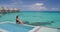 Pool Beach Luxury Winter Vacation Woman in bikini in luxury overwater bungalow