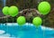 Pool with big green balloons outdoor. Poolside party. The balloons on water. Decorations for wedding ceremony by the pool