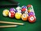 Pool or billiard balls and cue on green table cloth. 3D illustration