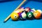 Pool billiard balls and cue on the table