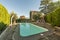 Pool of a detached house with a plot paved with stone slabs with the perimeter surrounded by hedges