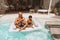 Pool. Father With Son Meditating And Floating On Inflatable Water Mattress. Dad And Kid Enjoying Vacation At Resort.