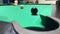 Pool game, a player on a billiard table pockets the last black ball into a pocket