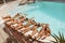 Pool. Group Of People Floating On Back With Legs On Poolside. Parents With Different Age And Gender Children.