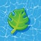Pool infantable green palm tree leaf mattress place on water texture.