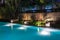 Pool lighting in backyard at night for family lifestyle and living area. Luxury design with good light and clean landscaping.