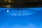 Pool lighting in backyard at night for family lifestyle and living area. Luxury design with good light and clean landscaping. pool